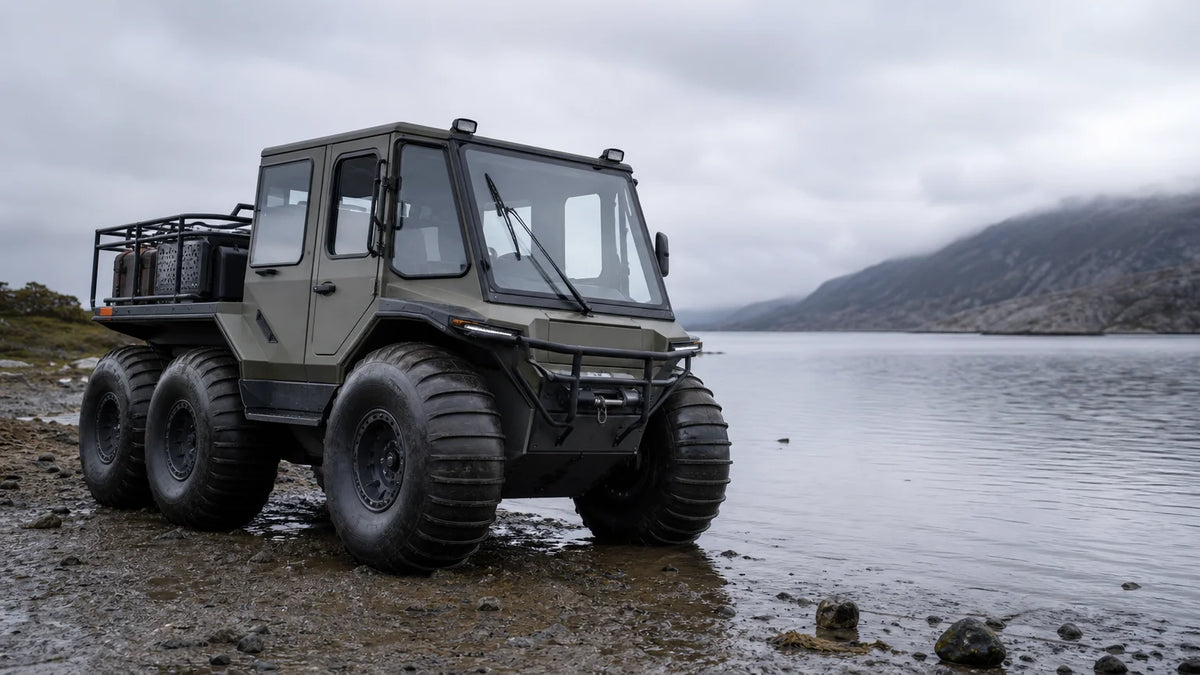 Amphibious all terrain utility vehicle with oversized tires beside shallow water