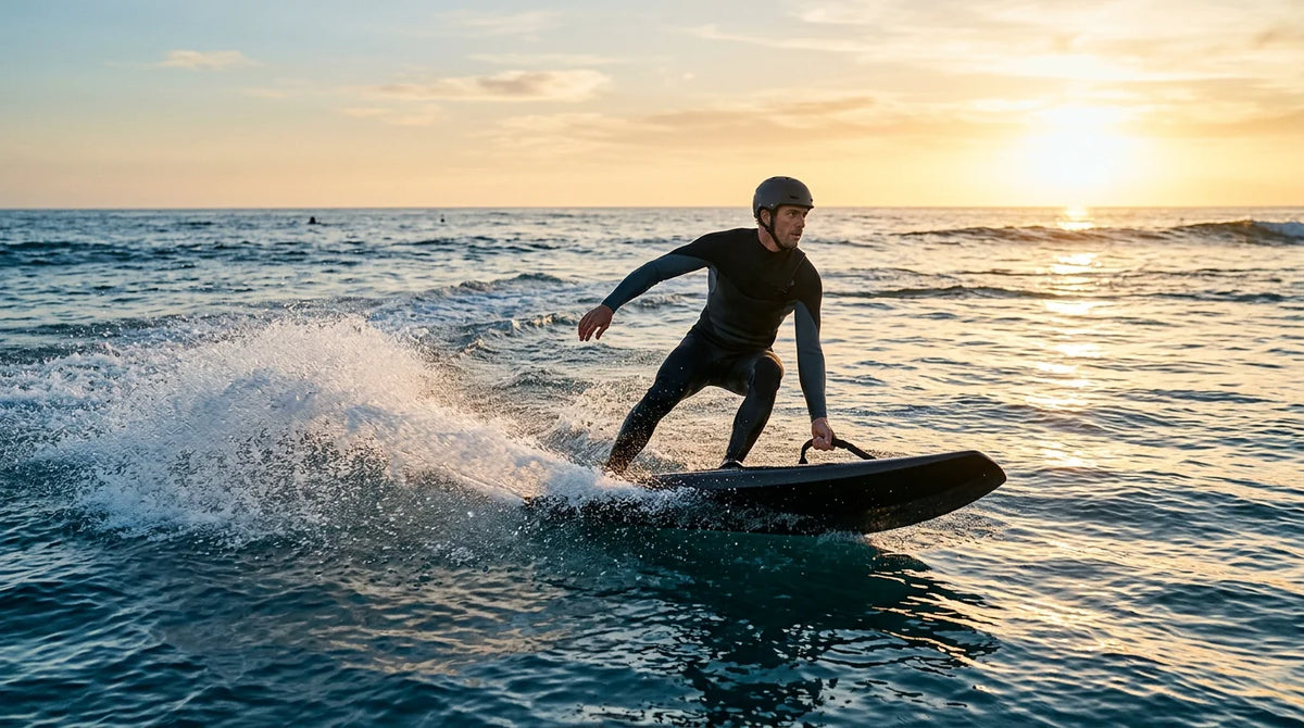 Rider on a sleek electric surfboard crossing open water at golden hour
