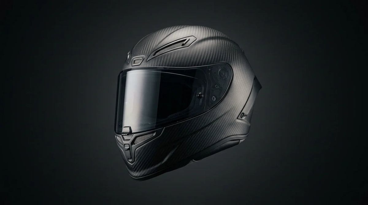 Luxury carbon fiber motorcycle helmet on a dark studio background