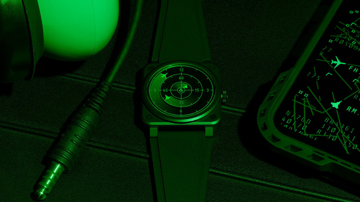 Bell & Ross BR-03 Green Radar Ceramic beside aviation equipment under green lighting