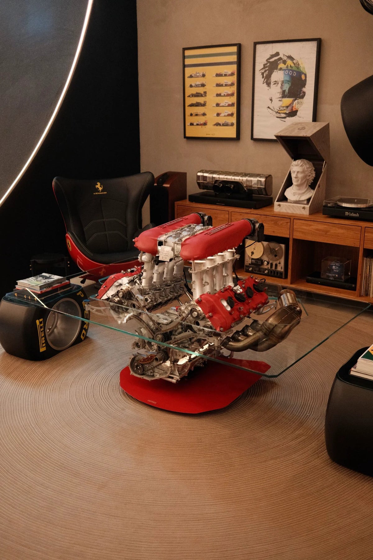 A red-and-silver engine assembly displayed on a red base in a warmly lit interior